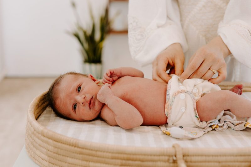 Person changing baby's diaper
