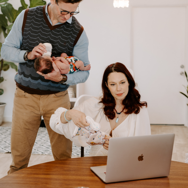 Mom, dad, and baby looking at a computer