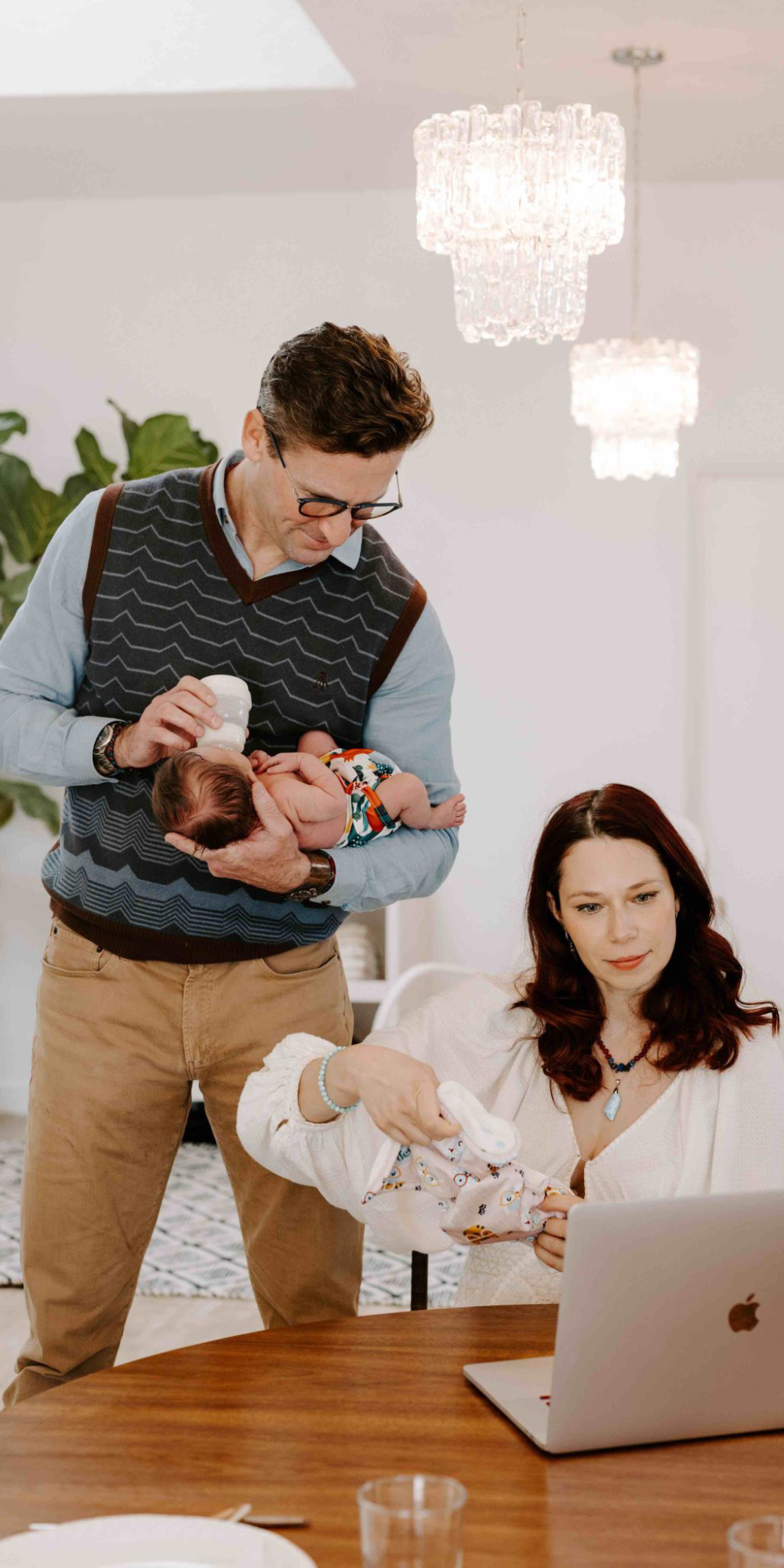 Mom, dad, and baby looking at a computer