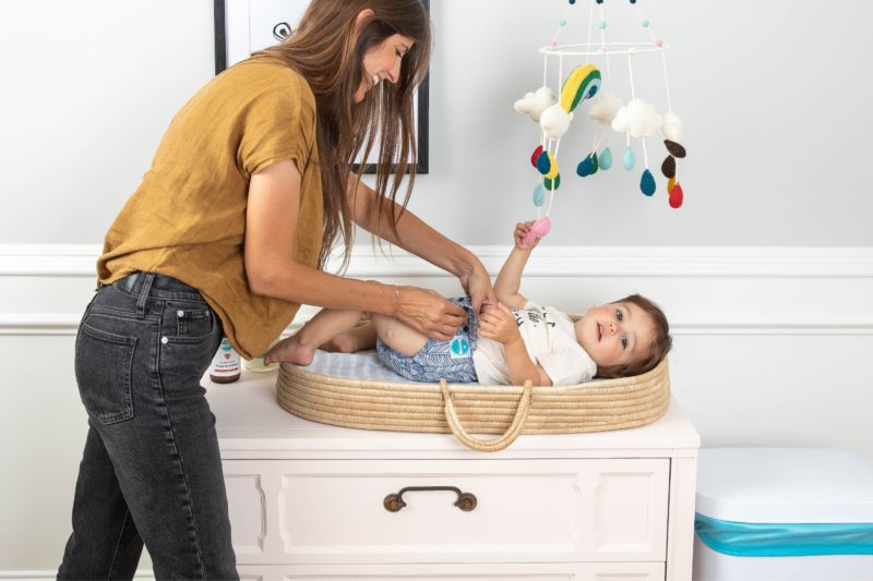 Woman changing baby with Luludew diaper